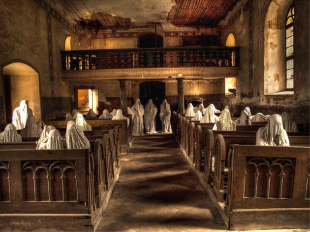 PIC FROM CATERS NEWS - (PICTURED: ghosts helo to save the church) A cursed church has been saved from closure thanks to a spooky art installation featuring dozens of creepy ghosts. St Georges church in the Czech village of Lukova was left to rot after part of the roof collapsed during a funeral service in 1968. Believing this to be a sign of bad luck, locals abandoned the medieval church and it was left to deteriorate for more than 30 years. SEE CATERS COPY.