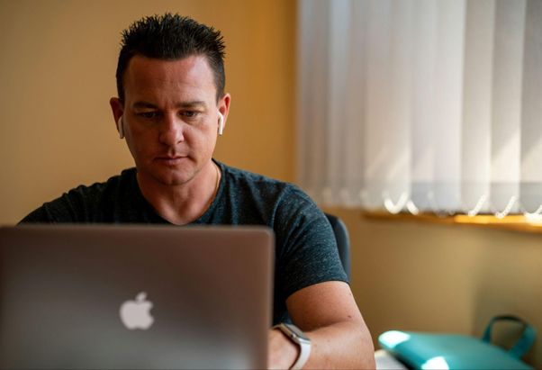 https://unsplash.com/photos/man-in-blue-crew-neck-t-shirt-using-silver-macbook-hhASRAL_1io